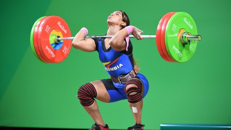 Woman weightlifter doing clean and jerk